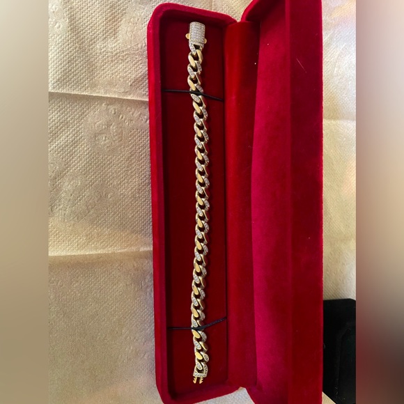 Gold Cuban bracelet semi iced out .